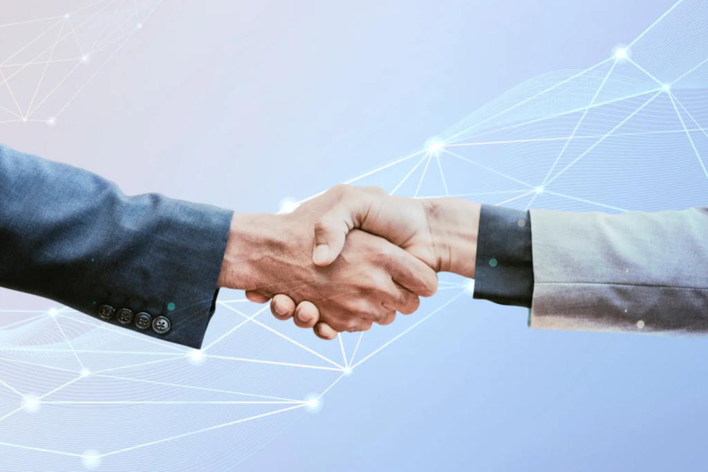 A business handshake overlaid with an abstract digital network and data graphic against a light blue background.